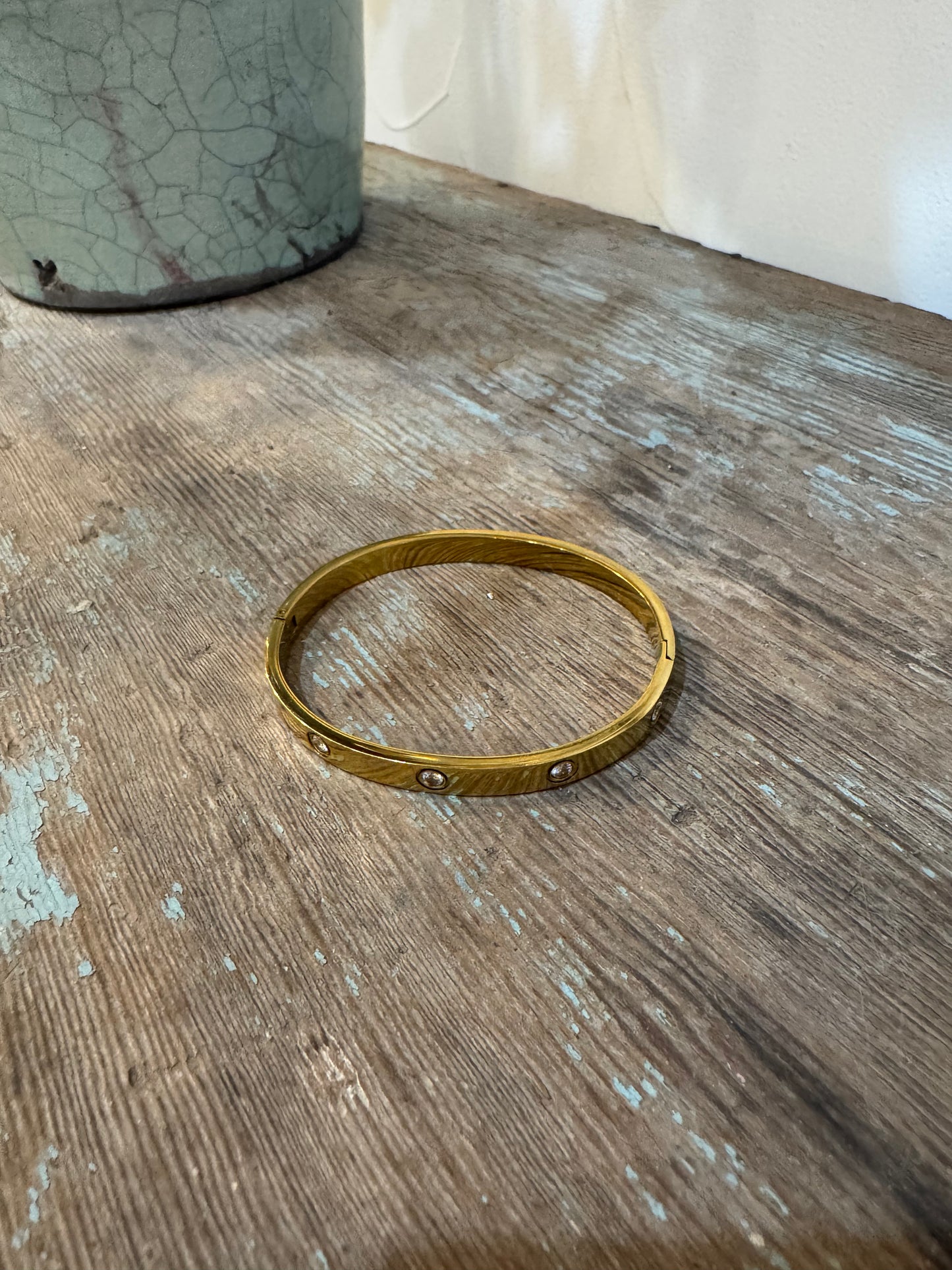 Gold bangle bracelet with CZ stones