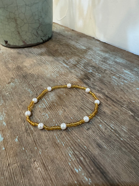 Gold colored stretch bracelet with pearls